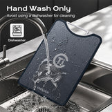 A dark gray textured silicone cutting board with a white handle, shown in a kitchen sink with water running from a faucet. Text overlays at the top read 'Hand Wash Only' and 'Avoid using a dishwasher for cleaning', with a dishwasher icon.