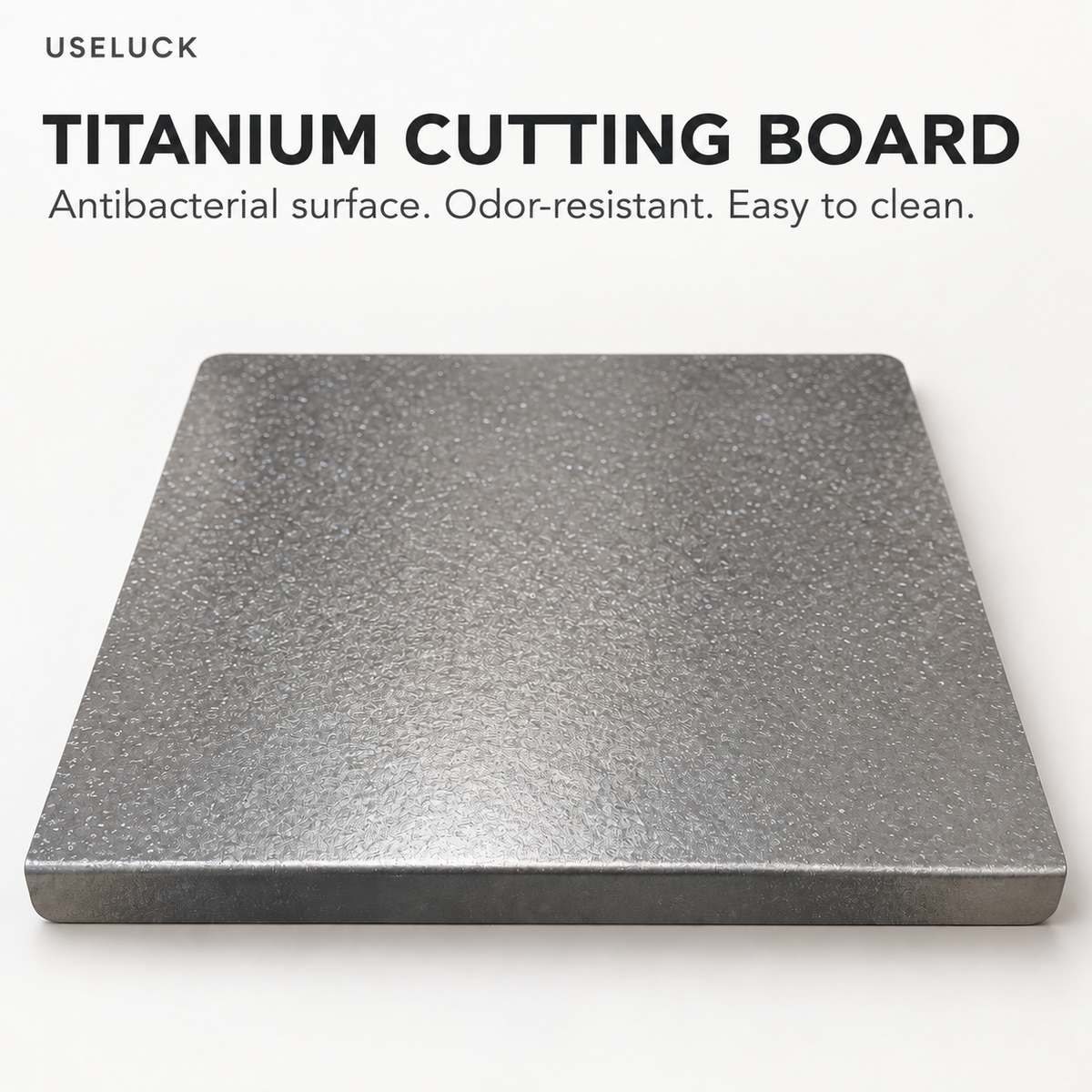 A square titanium cutting board with a textured metallic gray surface, shown on a clean white background with promotional text at the top.